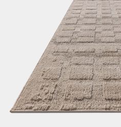 a beige rug with squares on it