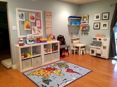 a child's playroom with toys and bookshelves on the floor,