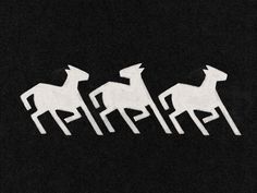 three white paper cut horses on a black background with space for your text or image