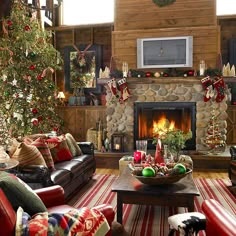 a living room filled with furniture and a fire place under a christmas tree in front of a flat screen tv