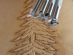 a close up of a piece of cloth with metal tools attached to it and on top of the fabric