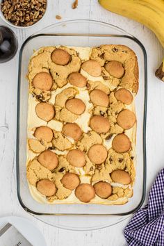 a pan filled with cookies and other desserts sitting on top of a white table