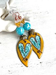 "Love and Friendship  These boho style earrings were made with pretty enamels from AlisonPageStudios, faceted shell beads, rhinestone spacers, metal bead caps, bell flower beads, Czech glass beads, and sterling silver wires.  They measure 2 3/4\" in length.  OOAK." Dangle Heart Earrings As Gift, Unique Heart Drop Earrings As Gift, Artisan Heart Earrings For Pierced Ears As Gift, Artisan Heart Earrings As Gift, Artistic Heart Earrings As Gift, Artistic Heart-shaped Earrings For Gift, Handmade Heart-shaped Enamel Jewelry, Nickel-free Unique Heart Earrings, Unique Nickel-free Heart-shaped Earrings