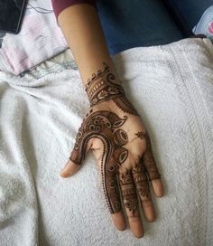 a woman's hand with henna on it