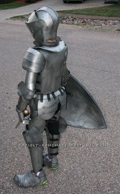 a man dressed as a knight standing in the street