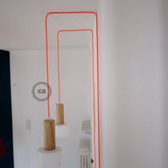 a room with white walls and orange lines on the wall