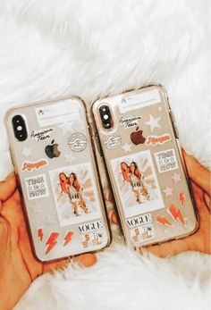 two iphone cases with stickers on them sitting next to each other in someone's hands