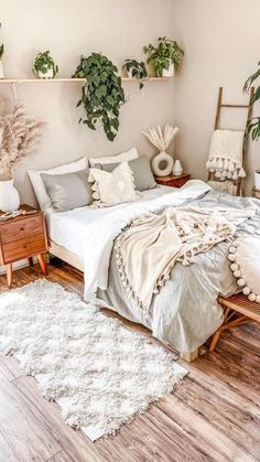 a bedroom with plants on the wall and a bed in the middle, surrounded by white rugs