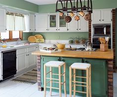 a kitchen with two stools in front of the island and an oven on the other side