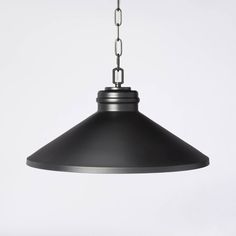 a black pendant light hanging from a chain