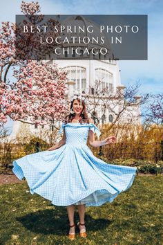 a woman in a blue dress is posing for the camera with her arms outstretched and hands out