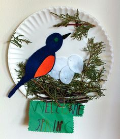 a paper plate with a bird sitting on top of it