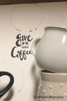 a coffee pot sitting on top of a table next to a cup with the words give me more coffee