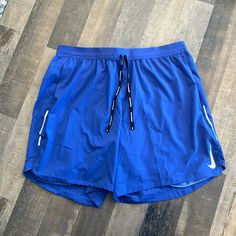 Never Been Worn- Standard Fit 7” Length Shorts Blue Bottoms With Built-in Shorts For Running, Nike Blue Activewear With Built-in Shorts, Blue Running Activewear With Pockets, Nike Workout Bottoms With Pockets, Blue Activewear With Pockets And Short Legs, Blue Sports Bottoms With Pockets, Blue Nike Athletic Shorts For Gym, Nike Stretch Athletic Shorts With Pockets, Nike Blue Running Shorts