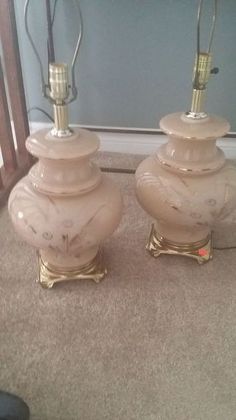 two lamps sitting on top of a carpeted floor