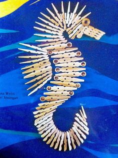 an image of a seahorse made out of toothpicks on blue water with yellow moon in the background