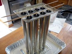 a stove top with four burners on it sitting on a wooden table in a kitchen