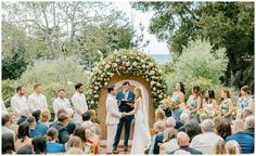 a couple getting married in front of an outdoor ceremony