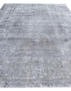 an antique rug with faded edges in shades of grey and white, on a white background