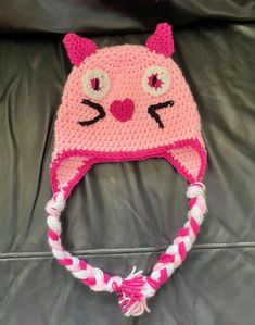 a crocheted hat with a cat face on it