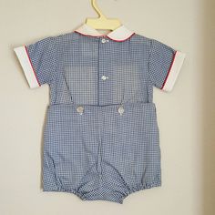 - This adorable outfit by C.I. Castro and Co. is perfect for any occasion. It is 2 pieces and navy blue gingham with a white collar piped in red. Across the chest is a retro ribbon with clowns and blocks. It buttons down back and snaps between legs. Sizes are: 9 months (21 available) 12 months (3) Cute Fitted Gingham Sets, Plaid Cotton Playtime Set, Gingham Cotton Short Sleeve Set, Preppy Fitted Cotton Sets, Gingham Cotton Set With Short Sleeve, Navy Cotton Playtime Sets, Fitted Gingham Cotton Sets, Cotton Navy Sets For Playtime, Sailor Shirt