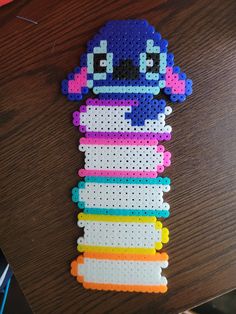 a stack of plastic beads sitting on top of a wooden table