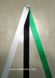 two pieces of black, white and green ribbon