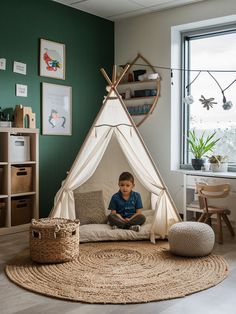 a young boy sitting in a teepee tent on top of a rug next to a window