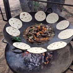 an outdoor grill with food cooking on it