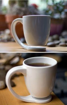 two cups of coffee sitting on top of a wooden table