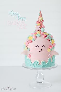 a birthday cake decorated like a narwhale cupcake with flowers on top