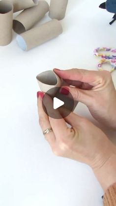 a woman is making some paper tubes out of toilet rolls