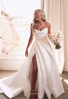 a woman in a white wedding dress is posing for the camera with her legs high