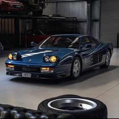 a blue sports car parked in a garage