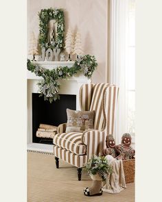 a living room decorated for christmas with wreaths on the mantel and striped chair