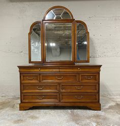 an antique dresser and mirror are shown against a white brick wall in this image, there is no one sitting on it