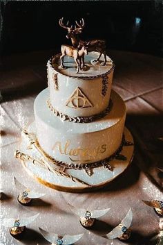 a three tiered cake with an image of a deer on top