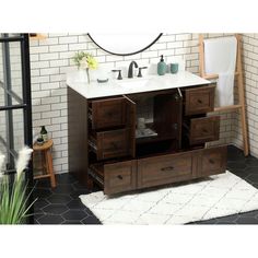 a bathroom vanity with two drawers and a mirror on the wall next to a rug