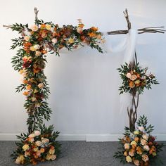 an arch decorated with flowers and branches