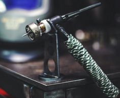 a close up of an electronic device on a table with a tv in the background