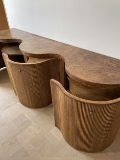 two curved wooden tables sitting next to each other