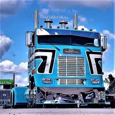 a large blue semi truck parked in a parking lot