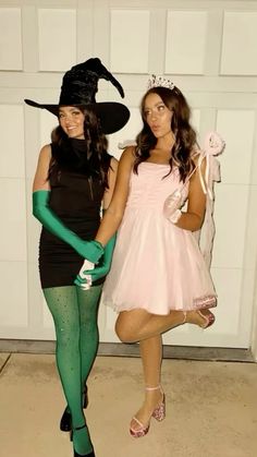 two women dressed up in costumes posing for the camera