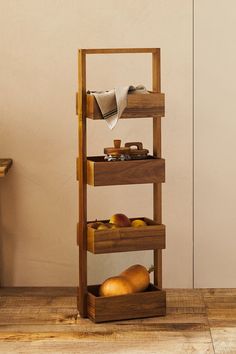 a wooden shelf with fruit and bread on it