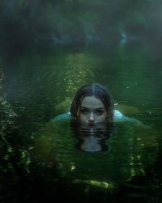 a woman floating in the water with her head submerged