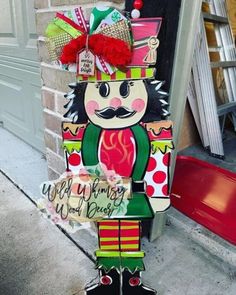 a wooden sign with a nutcracker on it's head and name in the middle