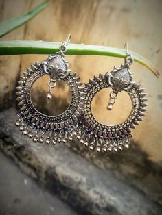 Elevate your style with these Handmade Oxidized Silver Tribal Hoop Earrings, a perfect blend of bohemian and ethnic charm. These earrings feature intricate detailing in a circular hoop design, finished with oxidized silver and adorned with small dangling silver beads for added movement and elegance. The unique craftsmanship makes these earrings ideal for both casual and festive occasions, whether it's a wedding, festival, or party. The boho-inspired and tribal design of these earrings ensures th Silver Jhumka Earrings, Thoughtful Gifts For Her, Jhumki Earrings, Bollywood Style, Indian Earrings, Ethnic Earrings, Jhumka Earrings, Indian Traditional, Contemporary Outfits