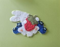 an embroidered patch with a teddy bear sleeping on it's back in the shape of a cloud