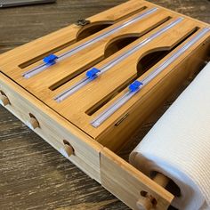 a roll of toilet paper sitting on top of a wooden box