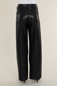 Elevate your professional outfits (or even just your everyday looks) with an edgy wardrobe staple like our Faux Leather Wide Leg Trouser Pants. Tailored to perfection, these wide legged trousers offer a relaxed yet polished vibe, ideal for curating a smart casual look. The sleek faux leather material lends a modern edge, while the wide leg cut ensures a comfortable, airy feel. Pair these with a crisp blouse or a casual tee to create versatile looks that transition effortlessly from office hours Sleek Dress Pants For Night Out In Fall, Chic Wide-leg Leather Pants For Workwear, Trendy Wide Leg Dress Pants For Formal Occasions, Elegant Wide Leg Leather Pants For Night Out, Sleek Wide Leg Workwear Pants Full Length, Sleek Wide Leg Leather Pants For Night Out, Elegant Wide-leg Leather Pants For Night Out, Sleek Leather Straight Pants For Office, Sleek Straight Leather Pants For Office